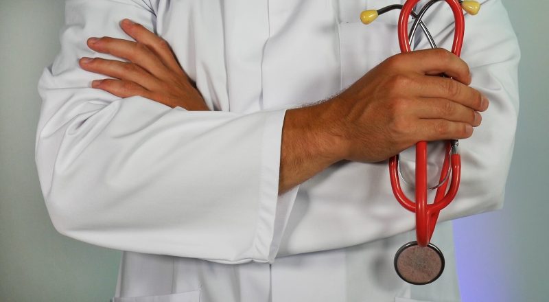 doctor holding red stethoscope